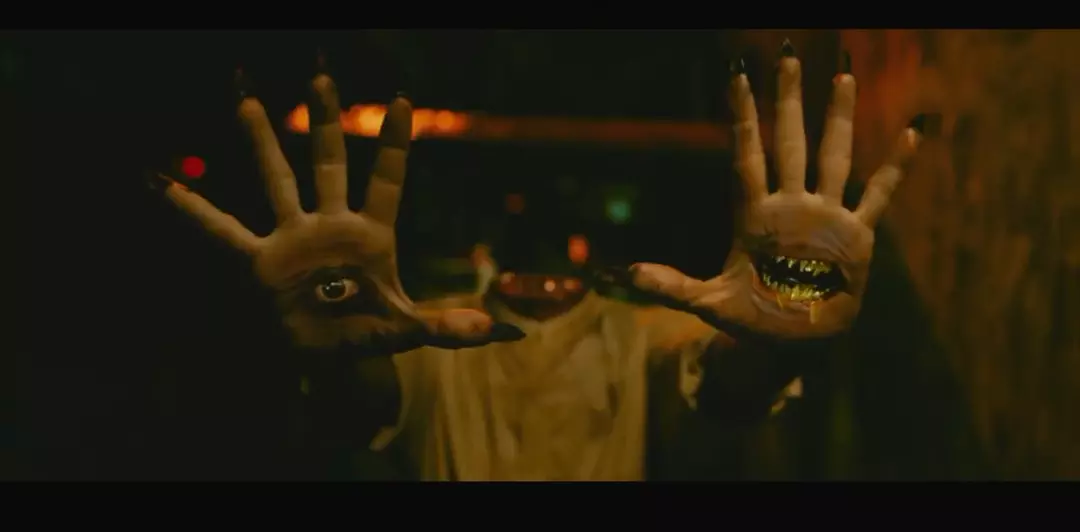 Hands with an eye and a mouth in Chuyện ma gần nhà, creating a creepy atmosphere.