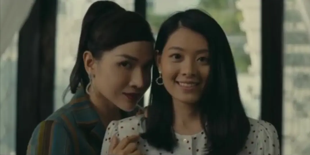 Two women standing close in Chuyện ma gần nhà, with one smiling.