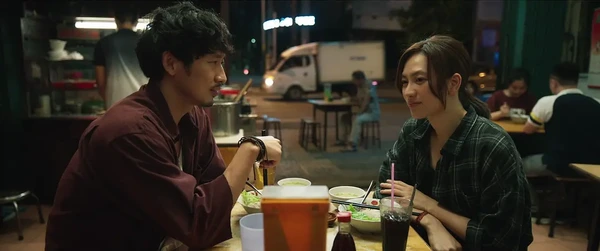 In Mai, a man and woman are having a meal outdoors, seemingly in deep conversation.