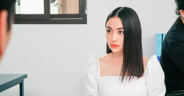 Woman in white dress in a scene from "Trên Cả Tình Thân".